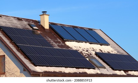 Self-cleaning Effect Of Solar Systems. Photovoltaic Panels Vs. Thermal Solar Panels. Energy Production On The Roof Of The House.