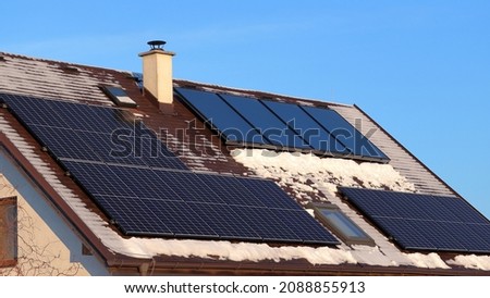 Self-cleaning effect of solar systems. Photovoltaic panels vs. thermal solar panels. Energy production on the roof of the house.