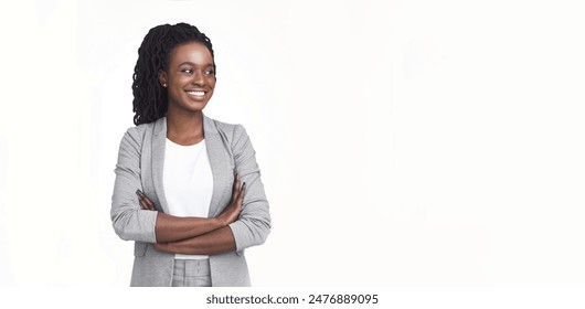 Self-confident African American corporate woman dressed in a grey blazer and glasses, isolated on a white background, with plenty of copy space for text. - Powered by Shutterstock