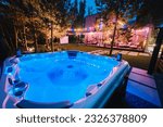 self-contained hot tub or pool with hot water and evening lighting.