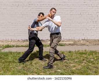 Self-defense of a Krav Maga against a knife attack. Martial arts instructors demonstrate self-defense techniques of Krav Maga - Powered by Shutterstock