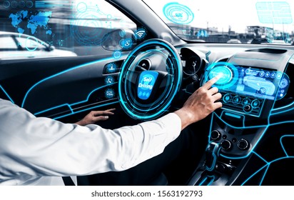 Self-driving Autonomous Car With Relaxed Young Man Sitting At Driver Seat Is Driving On Busy Highway Road In The City. Concept Of Machine Learning, Artificial Intelligence And Augmented Reality.