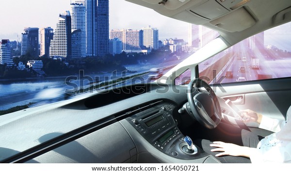 Self-driving autopilot mode, autonomous car,\
vehicle running self-driving mode and a woman driver Transportation\
with electric car\
concept