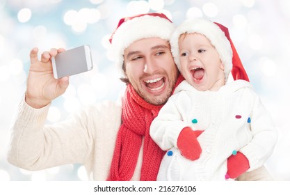 Selfe  In Winter. Happy Family Father Dad Playing With Baby Daughter And Photographed On A Mobile Phone