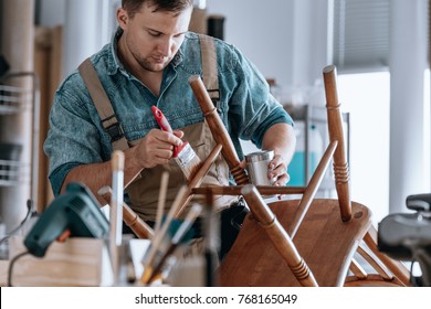 Self-employed Carpenter Painting Wooden Chair At Carpentry