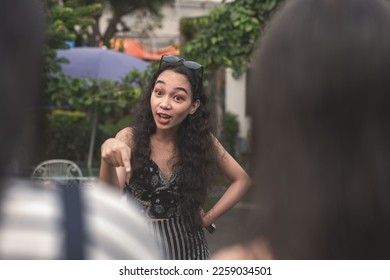 An self-entitled and mean young woman lectures and berates two poor women about their looks and social status. - Shutterstock ID 2259034501