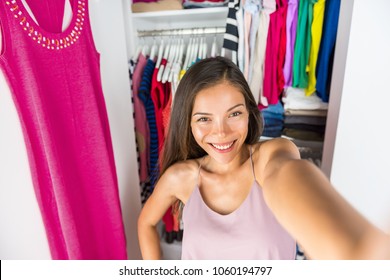 Selfie Asian Girl Taking Photo With Mobile Phone Of Herself In Closet Dressing Room At Home Trying On Outfit. Clothes Fashion Style. Shopping Girl Using Smartphone Fashion App Posting On Social Media.