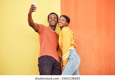 Selfie, black couple and smile with gen z youth, smartphone and influencer with post for social media against color wall background. Happy in picture, fashion mockup and tech with young man and woman - Powered by Shutterstock