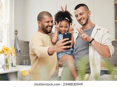 Selfie, blended family and a happy girl with her gay parents in the kitchen together for a profile picture. Adoption photograph, smile or love and a playful daughter with her lgbt father in the home