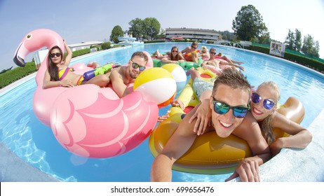 SELFIE: Cheerful Happy Friends Making Selfie On Fun Colorful Floaties In Pool