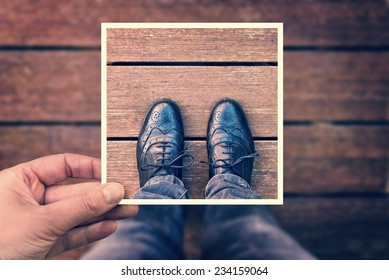 Selfie Of Foot And Legs With Black Derby Shoes Seen From Above With Hand Holding An Instant Photo Frame, Vintage Process