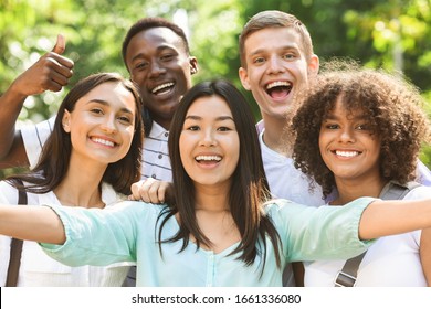 Selfie Fun. Group of multi-ethnic teen friends taking self portrait picture outdoors and sincerely smiling at camera - Shutterstock ID 1661336080