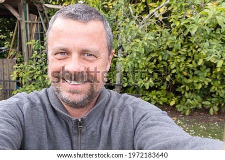 Selfie handsome guy middle aged man outdoor home garden park cheerful guy making a photo