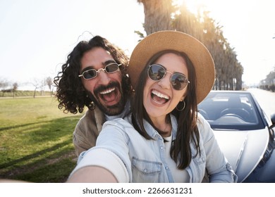 Selfie happy couple friends with big smiles. Young people taking photo of summer trip. Man and woman posing excitedly outside of car. Concept of youth, relationship, holidays and vacation. - Powered by Shutterstock