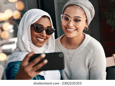 Selfie, happy muslim and women or friends in city for social media, influencer content creation and fashion blog. Young gen z people in Saudi Arabia with profile picture, photography and sunglasses - Powered by Shutterstock