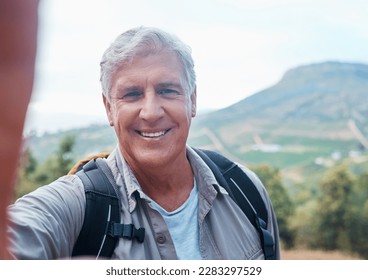 Selfie, hiking and portrait of old man on mountain for outdoor adventure, freedom and wellness in nature. Retirement, traveling and happy senior male take picture on hike, trekking and summer holiday - Powered by Shutterstock