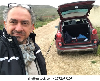 Selfie Of A Middle Aged Italian Man With Gray Beard And Short Rich Gray Hair Wearing Glasses And Black Vest In The Countryside For Sport Walking In The Countryside