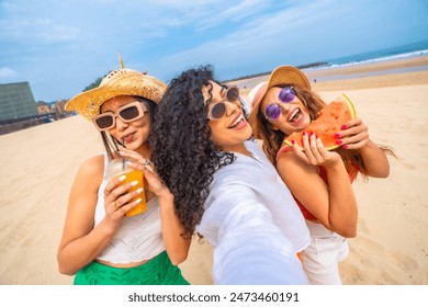 Selfie of multiethnic female friends enjoying summer on beach on vacation, outdoors smiling and laughing - Powered by Shutterstock