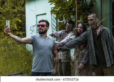 Selfie on a background of zombies, zombies tied to an abandoned house