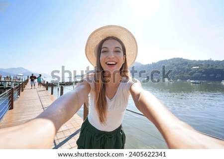 Selfie on Vacation. Tourist girl taking selfie photo on holiday in tropical destination.