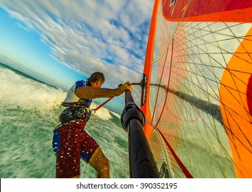 Selfie photo of windsurfing riding on colored sail