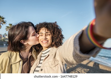 selfie photo of young multiracial couple of beautiful lovely girls smiling and kissing, concept of female friendship and racial diversity - Powered by Shutterstock