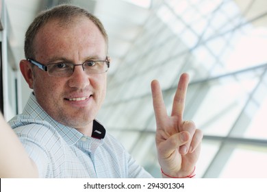 Selfie Portrait Of A Handsome 35 Years Old Man Smiling Indoor