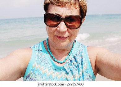 Selfie portrait of senior woman on the beach - Powered by Shutterstock