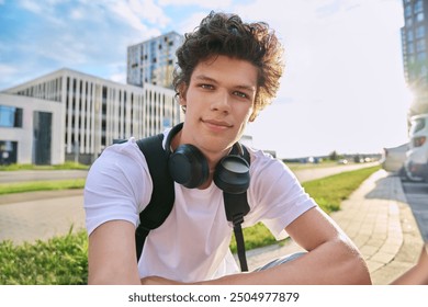 Selfie portrait of young handsome man with curly hair, outdoor - Powered by Shutterstock