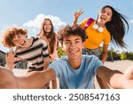 Selfie shot of crazy young people friends college students school pupils classmates teenagers having fun together spend time summer weekend in skate park outside urban street. Friendship concept