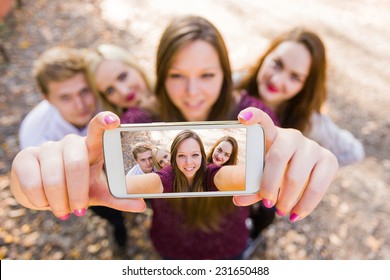 Selfie For Social Network With Photobomb With A Group Of Young People.