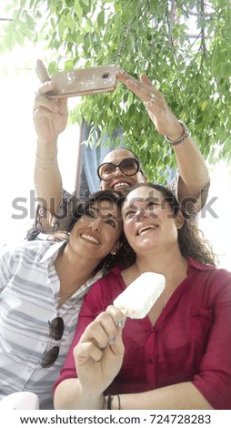 Similar – Männerhände fotografieren zwei glückliche Frauen im Freien.