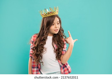 Selfish Child With Curly Hair Pointing Finger On Queen Crown On Blue Background, Arrogance