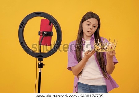selfish teen girl influencer with crown isolated on yellow. teen girl influencer with crown in studio.