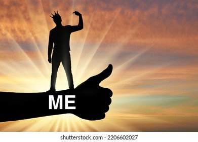 Selfishness and narcissism. A selfish man with a crown on his head points his finger at himself. The concept of egoism and narcissism. Social problems. Silhouette - Shutterstock ID 2206602027