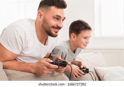 Self-isolated Dad And Son Playing Video Games At Home During Quarantine, Free Space