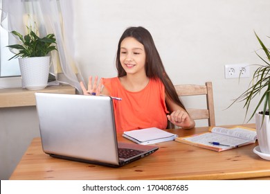 Self-isolated Girl Talking To Teacher Online And Doing Homework, Watching Online Lesson Webinar At Laptop.  Distance Education, Homeschooling, E-learning At Home During Quarantine Concept