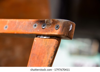 A Self-isolation Class Is A Chair Repair. Grandfather Repairs A Chair On The Street, Using Screws, Glue, And A Vice.