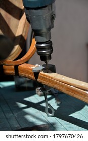 A Self-isolation Class Is A Chair Repair. Grandfather Repairs A Chair On The Street, Using Screws, Glue, And A Vice.