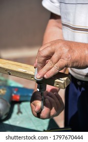 A Self-isolation Class Is A Chair Repair. Grandfather Repairs A Chair On The Street, Using Screws, Glue, And A Vice.