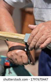 A Self-isolation Class Is A Chair Repair. Grandfather Repairs A Chair On The Street, Using Screws, Glue, And A Vice.