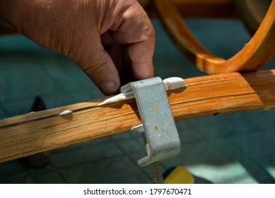 A Self-isolation Class Is A Chair Repair. Grandfather Repairs A Chair On The Street, Using Screws, Glue, And A Vice.