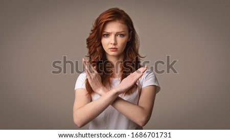 Self-Isolation. Determined Girl Gesturing No Crossing Hands Forbidding Something Posing Over Gray Background. Studio Shot, Panorama
