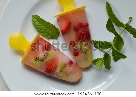 Selfmade ice popsicles with fresh fruits