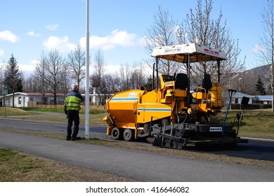 SELFOSS, ICELAND-MAY 4 :Workers Operating Man Calling Phone And Asphalt Paver Machine And Heavy Machinery During Repairs Road Under The Program Repairs Highway Road On May 4, 2016 In Selfoss, Iceland.