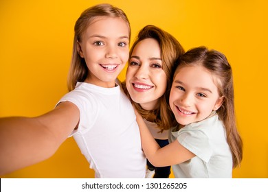 Self-portrait of three nice lovely attractive winsome dreamy cheerful cheery positive people cuddling mommy mum isolated over bright vivid shine yellow background - Shutterstock ID 1301265205