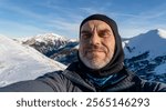 Self-portrait of a tourist in the winter mountains.