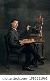 Self-portrait. Young man in art action remaking greatest paintings and its artists on old-fashioned background. Retro style, comparison of eras, fashionable characters concept. Artwork, classic.