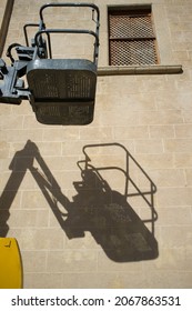 Self-propelled Articulated Boom Lift At Work. Basket On Shadows