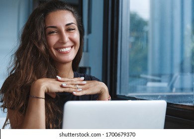 Self-quarantine, personal growth and development concept. Smiling woman working with computer remote home, employee get ready for online video-call interview, learning new skills while on lockdown